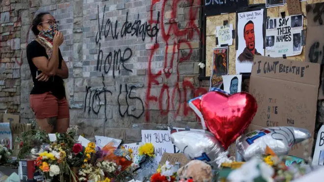 A woman reacts at a makeshift memorial honoring George Floyd, at the spot where he was taken into custody, in Minneapolis, Minnesota, U.S., June 1, 2020
