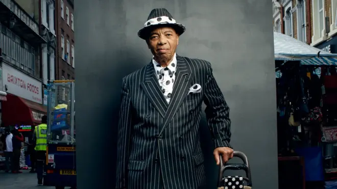 Portrait of a man in the street wearing a stripey suit