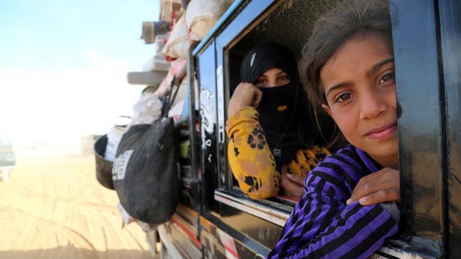 Syrian refugees in a van