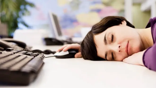 Woman lying on her desk