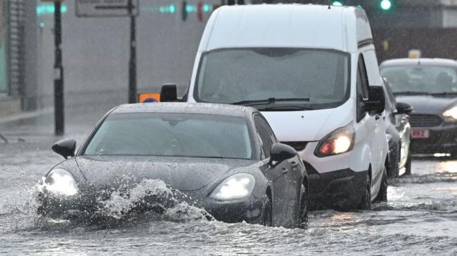 cars driving through flood water