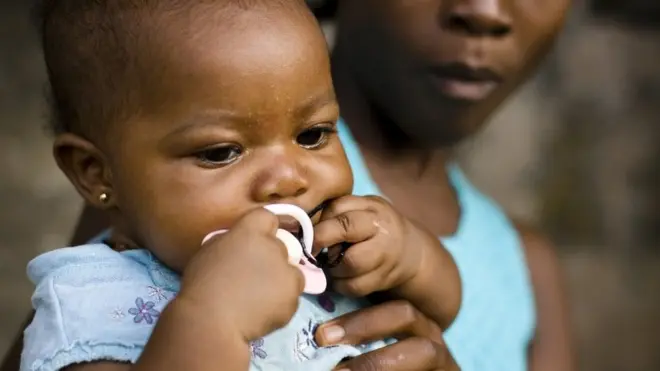 Stock image of woman holding a baby