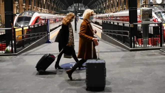 Commuters at Kings Cross train station in London, Britain, 20 December 2020.