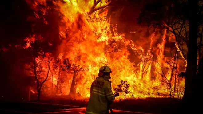 A firefighter tackles a blaze in New South Wales on Thursday