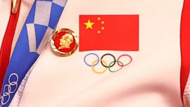 A Chinese cyclist wears a Mao badge during a medal ceremony at the Olympics