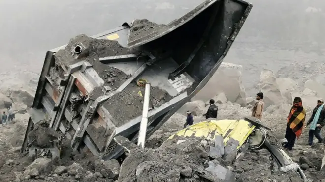 People gather near the site of a coal mine collapse near Lalmatia in Godda district in eastern Jharkhand state on December 30, 2016