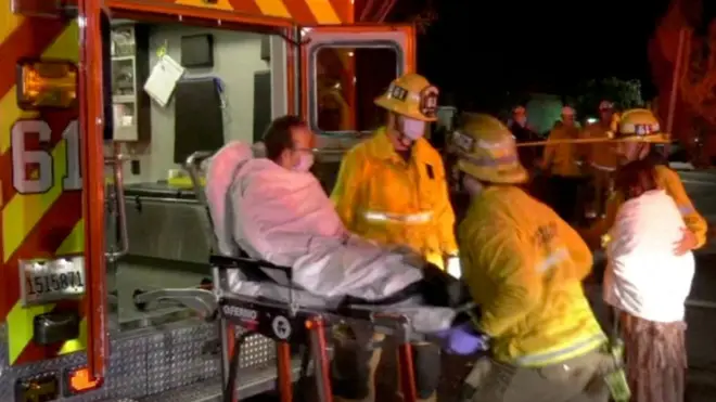 An injured festival attendee is loaded onto a stretcher