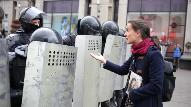 A woman addresses a Belarusian law enforcement officer during an opposition rally to protest against police brutality and to reject the presidential election results in Minsk, Belarus, 6 September