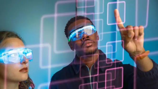 Futuristic image of a young man and young woman with smart glasses looking at a digital screen with computer code