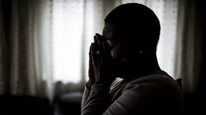 Silouette of pesin wey dey cover face