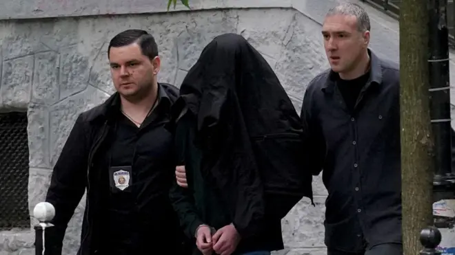 Police officers escort student wey do di shooting