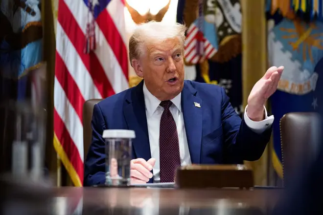 الرئيس الأمريكي دونالد ترامب خلال اجتماع وزاري في البيت الأبيض، يجلس أمام مكتبه