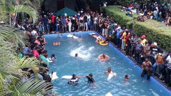 Protestors demanding the resignation of Sri Lanka's President Gotabaya Rajapaksa swim in a pool inside the compound of Sri Lanka's Presidential Palace in Colombo on July 9, 2022.