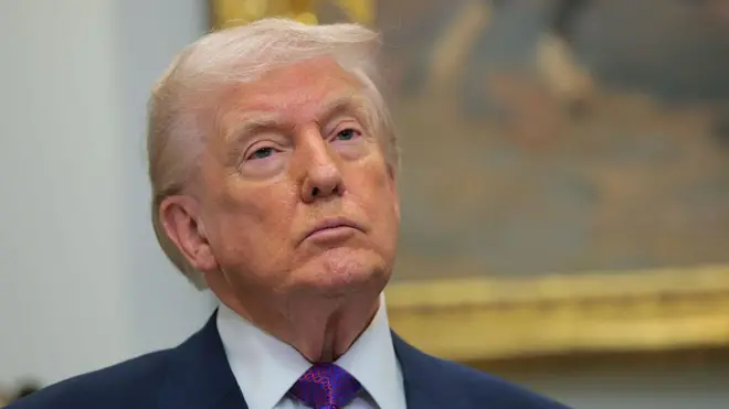 Donald Trump looks on