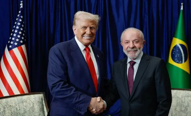 Trump e Lula (à direita) se cumprimentam 