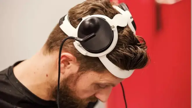 Sensors on Gert-Jan's head transmit his brain signals from an implant to a computer