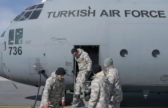 C-130'a malzeme taşıyan askerler. 