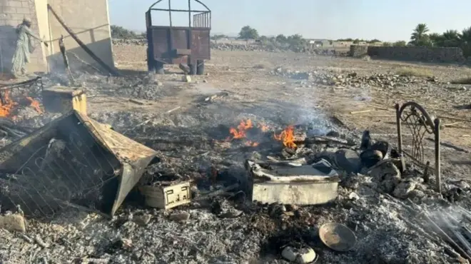 پر ځمکه د کور ځينې سوځېدلي توکي پراته دي چې اوس هم اور پرې بل دی.