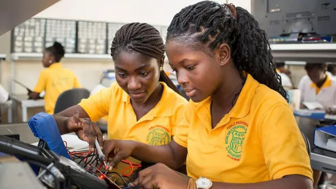 Dos jóvenes aprendiendo ingeniería eléctrica.