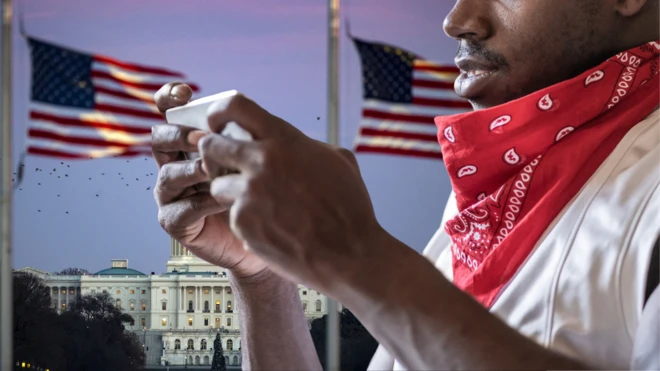 Man hold phone wit US flag at di back