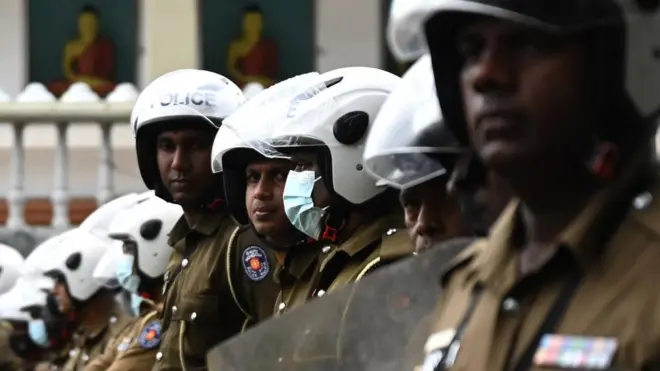 Police special task force personnel stand guard blocking a road as demonstrators (not pictured) take part in a protest march against Sri Lankan President Ranil Wickremesinghe towards the Presidential secretariat office in Colombo on July 22, 2022