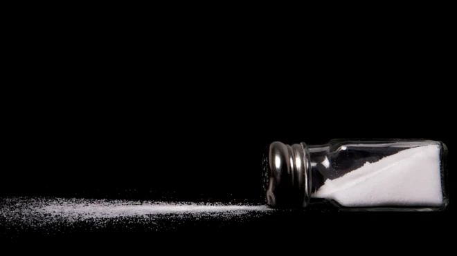 یک نمکدان افتاده و مقداری نمک ریخته شده