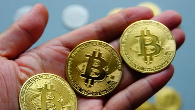Three Bitcoin coins for pesin hand