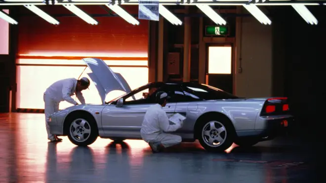 Workers carrying out quality inspection on car