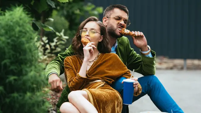 Man and woman eating meat