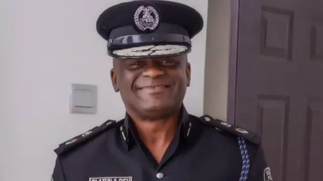 Tunji Disu, acting Inspector-General of police wear black police uniform