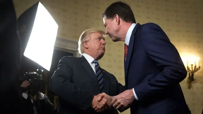 President Donald Trump, left, shakes hands with James Comey, then-director of the Federal Bureau of Investigation at the White House on 22 January, 2017. 