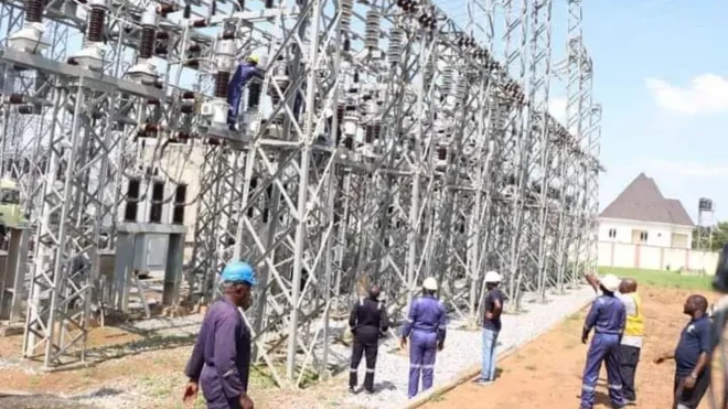 Officials gather round electricity infrastructure