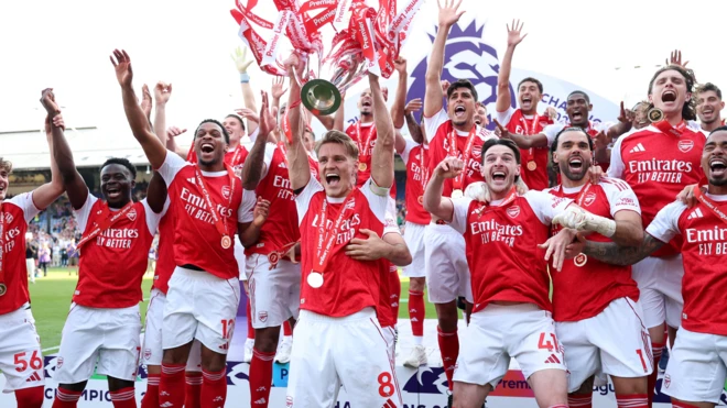 The Arsenal squad celebrate with the Premier League trophy
