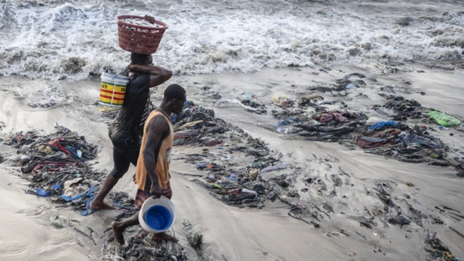 a beach coast in Accra inundated with textile waste