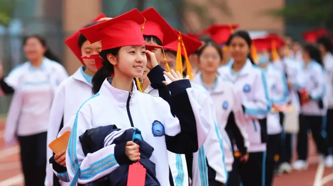 صفی از دانشجویان که با کلاه فارغ‌التخصیلی قرمز رنگ