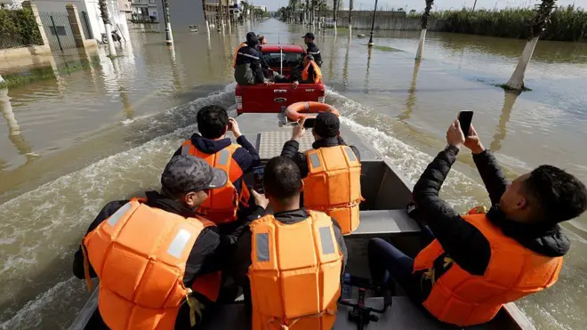أفراد من فرق إنقاذ مغربية يستقلون قوارب ويجوبون الشوارع وسط الفيضانات في مدينة القصر الكبير