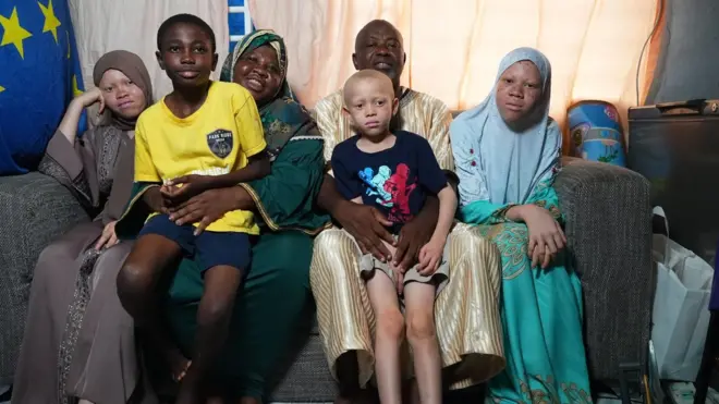 The Sambo family in a group photo with smiles.