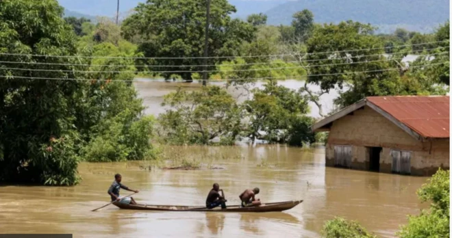 Three guys siddon inside one boat wey dey float ontop flood water