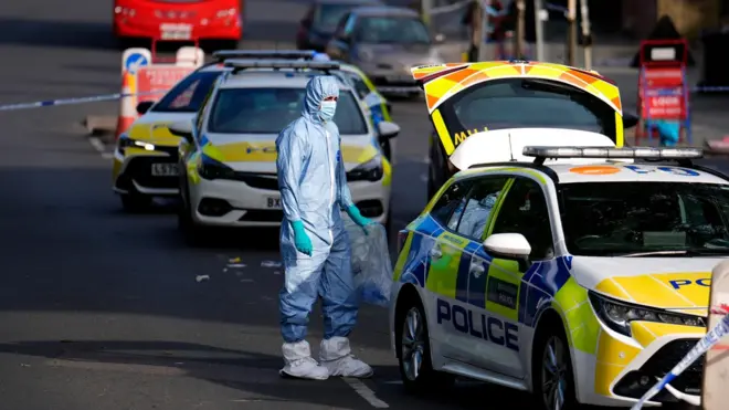 Police in forensic body suit at scene of stabbing in Golders Green 