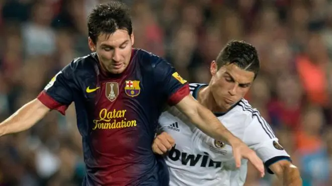 Cristiano Ronaldo playing for Real Madrid and Lionel Messi in action for Barcelona