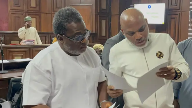 Nnamdi Kanu and one of im lawyers Patrick Agazie (on glasses) in plain clothe for di