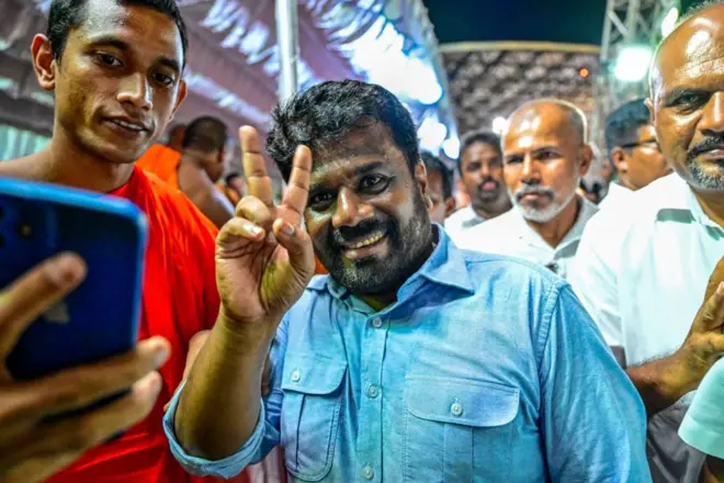 National People's Power (NPP) presidential candidate Anura Kumara Dissanayaka (2L), gestures during a rally ahead of the upcoming presidential elections in Colombo on September 18, 2024. Sri Lanka's presidential hopeful Anura Kumara Dissanayaka wants a peaceful revolution after his Marxist party failed to seize power in two uprisings that left more than 80,000 people dead. The cash-strapped nation will vote for its next president on September 21. (Photo by Ishara S. KODIKARA / AFP) (Photo by ISHARA S. KODIKARA/AFP via Getty Images)