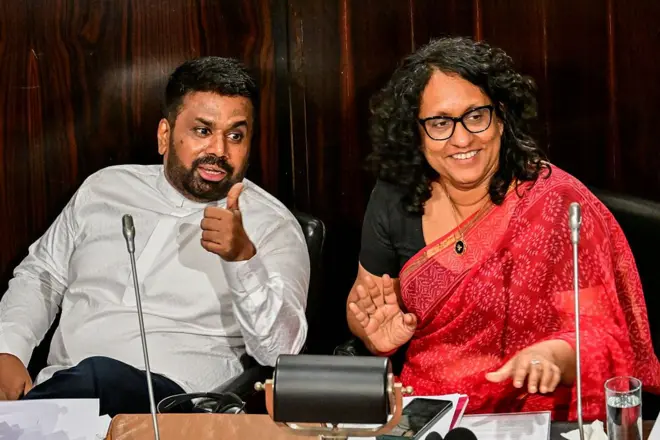 Sri Lanka's President Anura Kumara Dissanayake (L) gestures after presenting the 2026 budget to parliament as Prime Minister Harini Amarasuriya watches in Colombo on November 7, 2025.