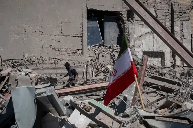 An unidentified man works among the ruins of a police station that is struck during U.S.-Israeli attacks in Tehran, Iran, on March 3, 2026.