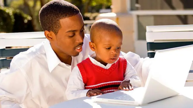 Young boy and his father using a computer