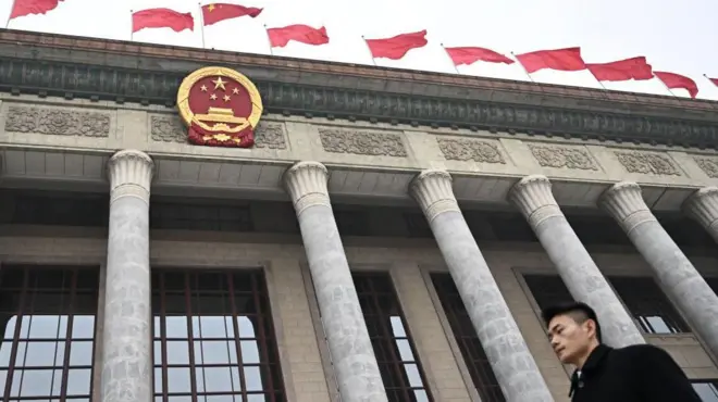 A security guard stands guard outside at the Great Hall of the People after the closing session of the National People's Congress (NPC) in Beijing on March 11, 2025.