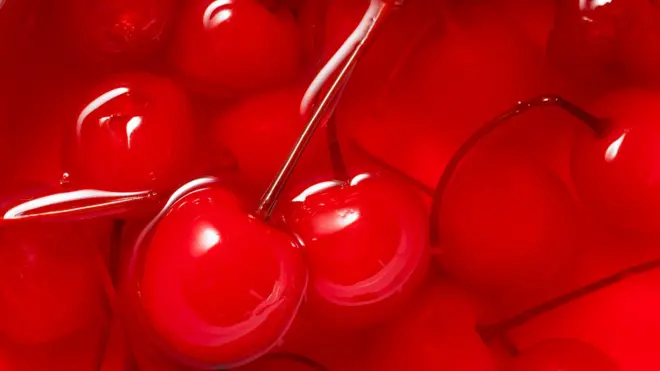 Close-up of bowl of bright red glace cherries