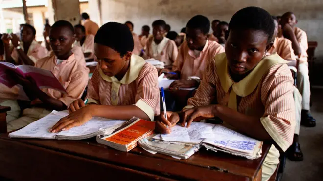 Nigerian students dey write during class for Lagos school.