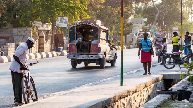 Personas caminando por el centro de la ciudad de Gonaïves.