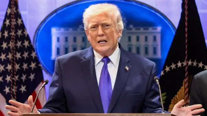 US President Donald Trump gestures as he speaks during a press briefing at the White House